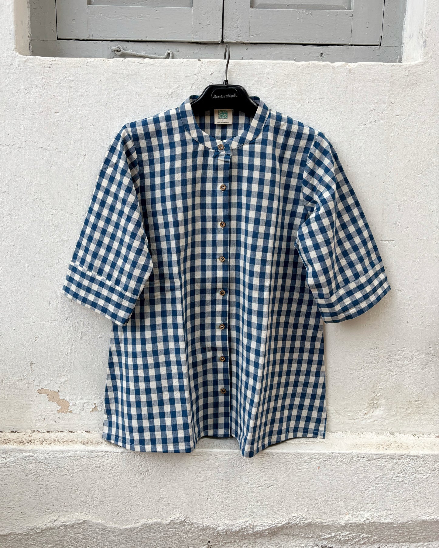 Indigo Meadow hand spun handwoven cotton checks shirt in deep indigo blue and natural ivory gingham with a band collar, wooden buttons and relaxed silhouette.
