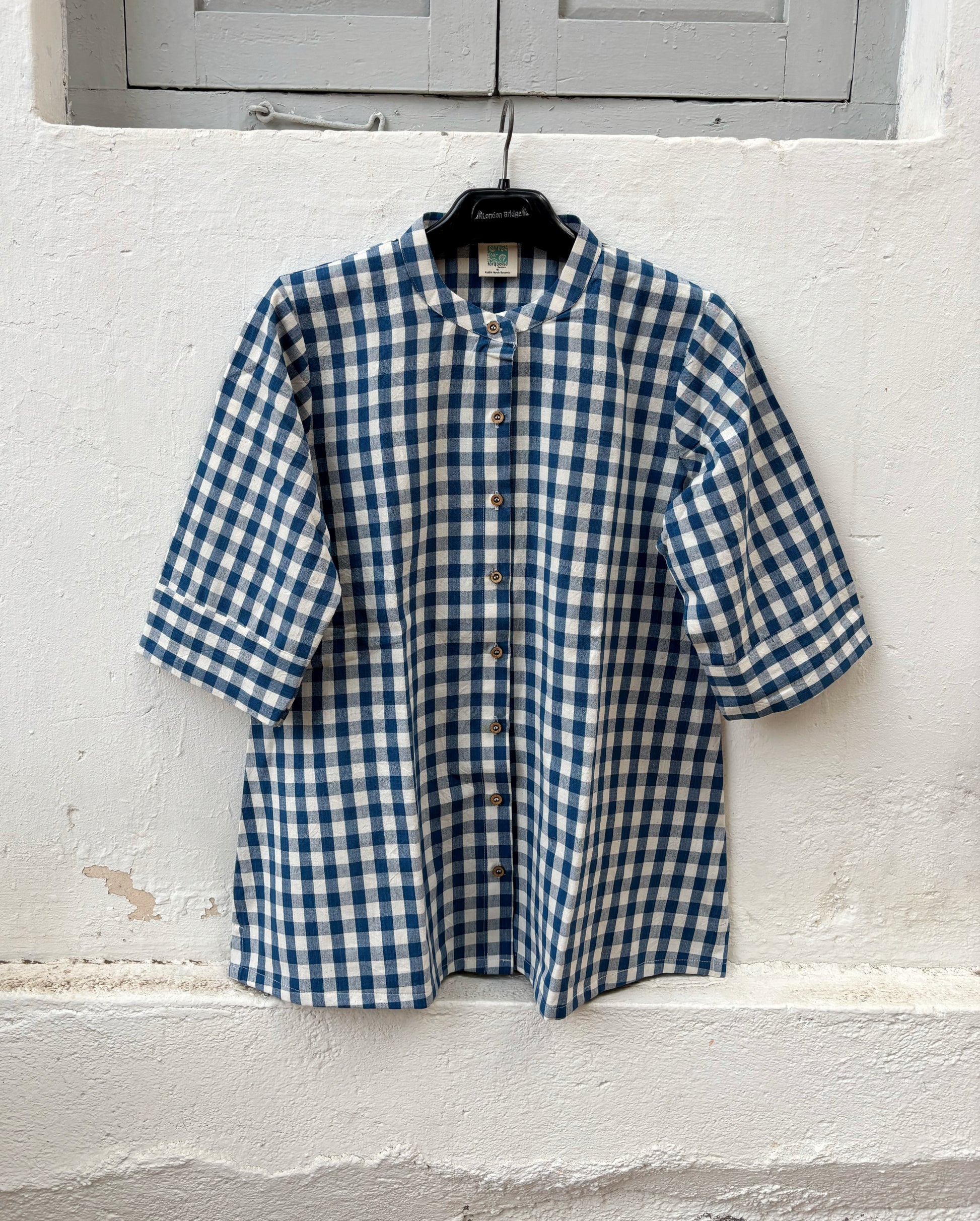 Indigo Meadow hand spun handwoven cotton checks shirt in deep indigo blue and natural ivory gingham with a band collar, wooden buttons and relaxed silhouette.