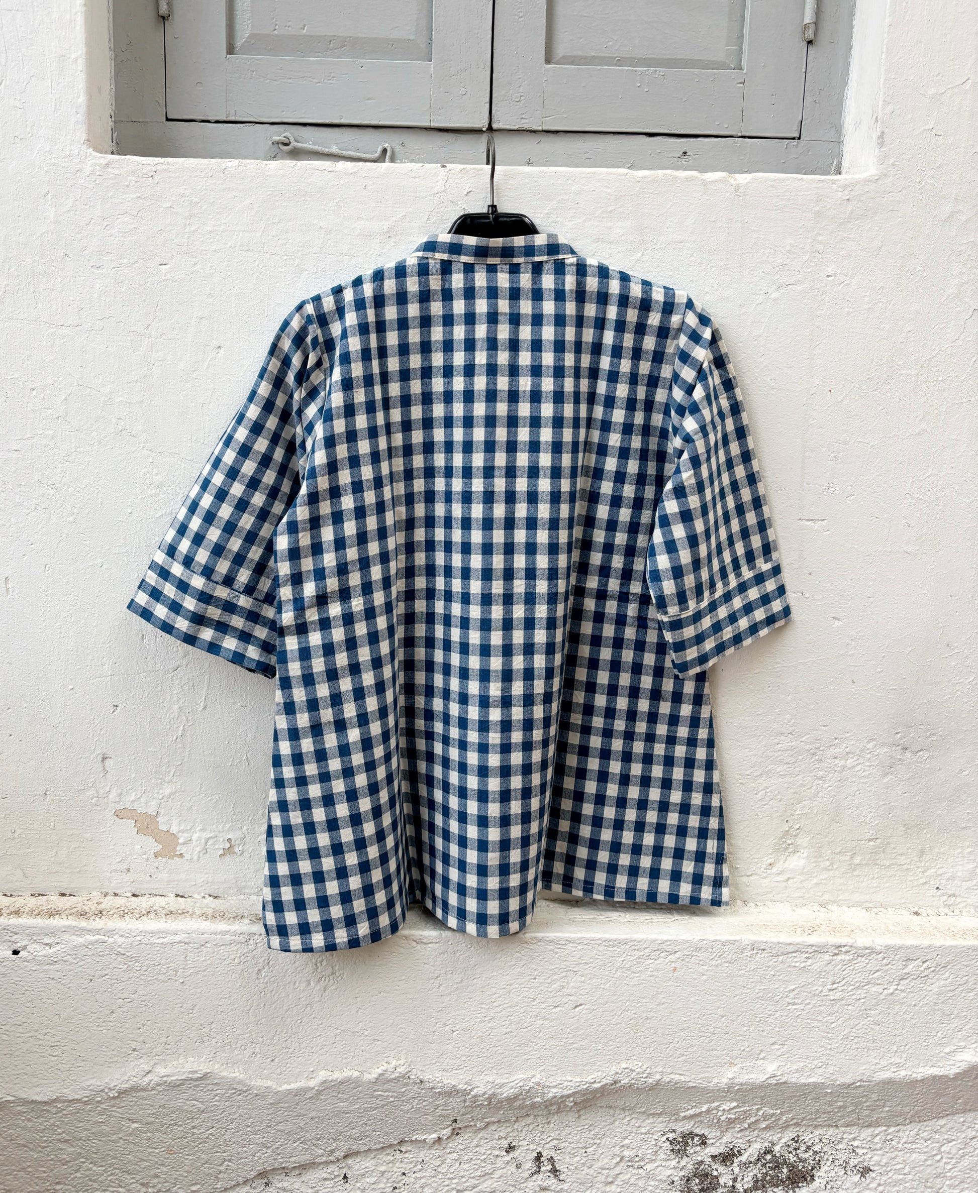 Indigo Meadow hand spun handwoven cotton checks shirt in deep indigo blue and natural ivory gingham with a band collar, wooden buttons and relaxed silhouette.