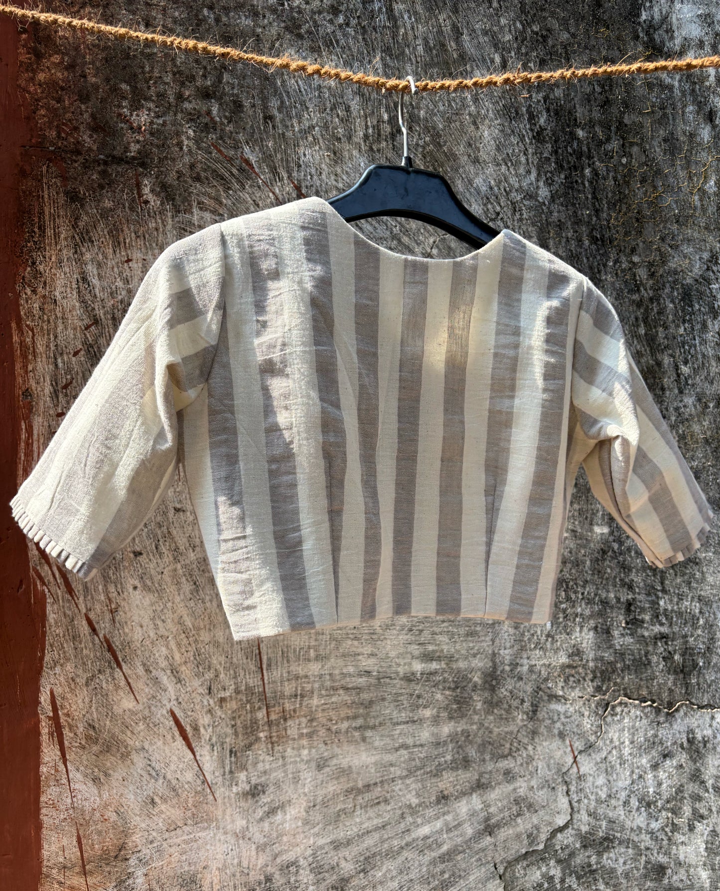 Handspun handwoven organic cotton blouse in ivory and grey stripes with round neck and wooden buttons, slow-made and handmade in India.