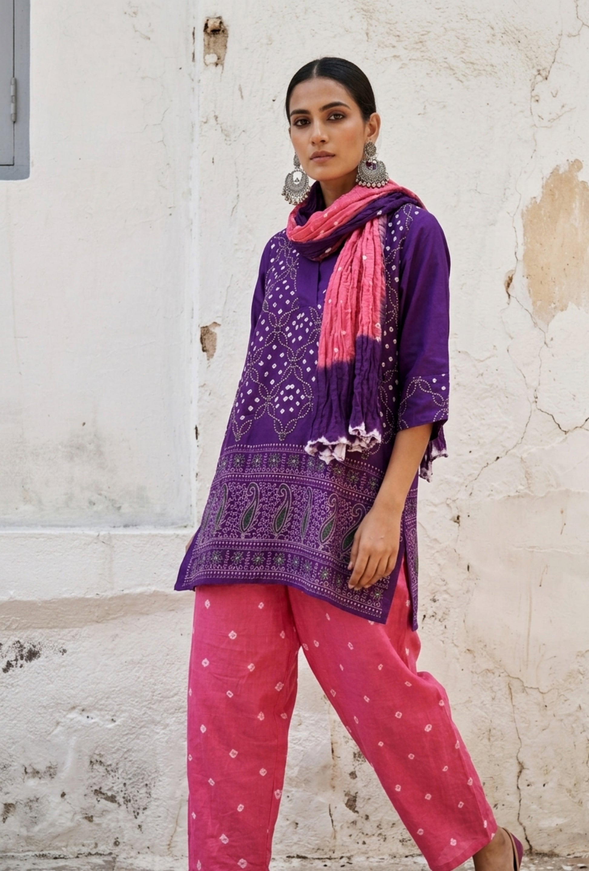 Purple and pink Bandhani three-piece set for women with embroidered top, comfortable-fit pants and hand tie dyed dupatta