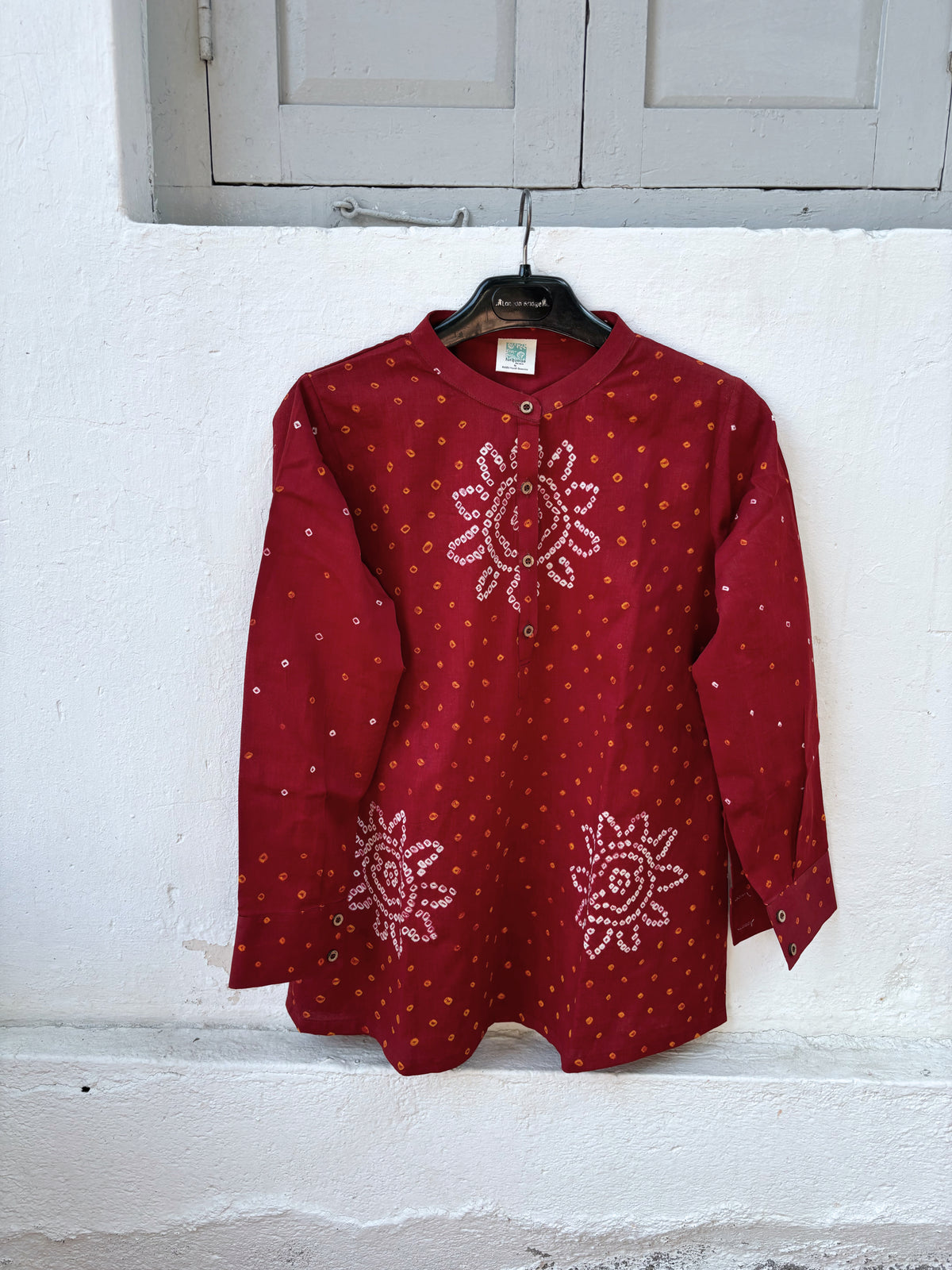 Jaswand deep red cotton shirt with turmeric-yellow and off-white hand tie-dyed Bandhani motifs, soft mandarin collar and partial button placket