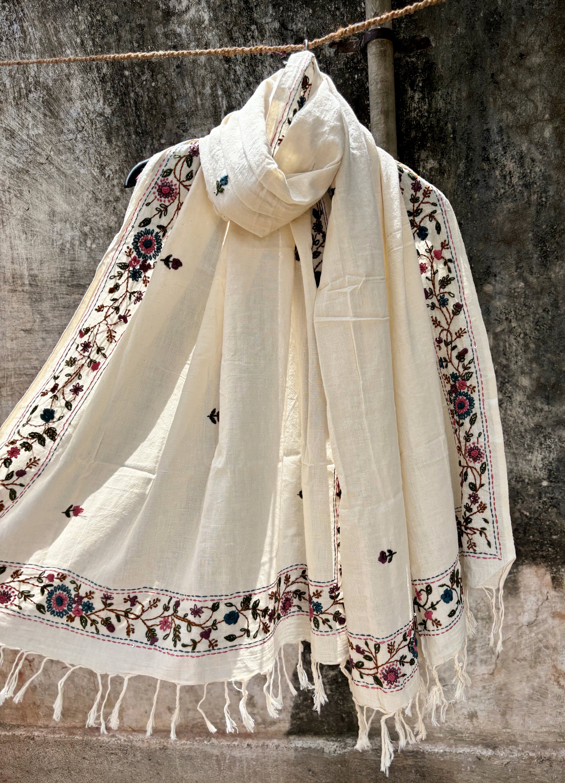 Juhi hand spun and handwoven off-white cotton dupatta with floral embroidered borders, scattered floral buds, and handcrafted tassels.