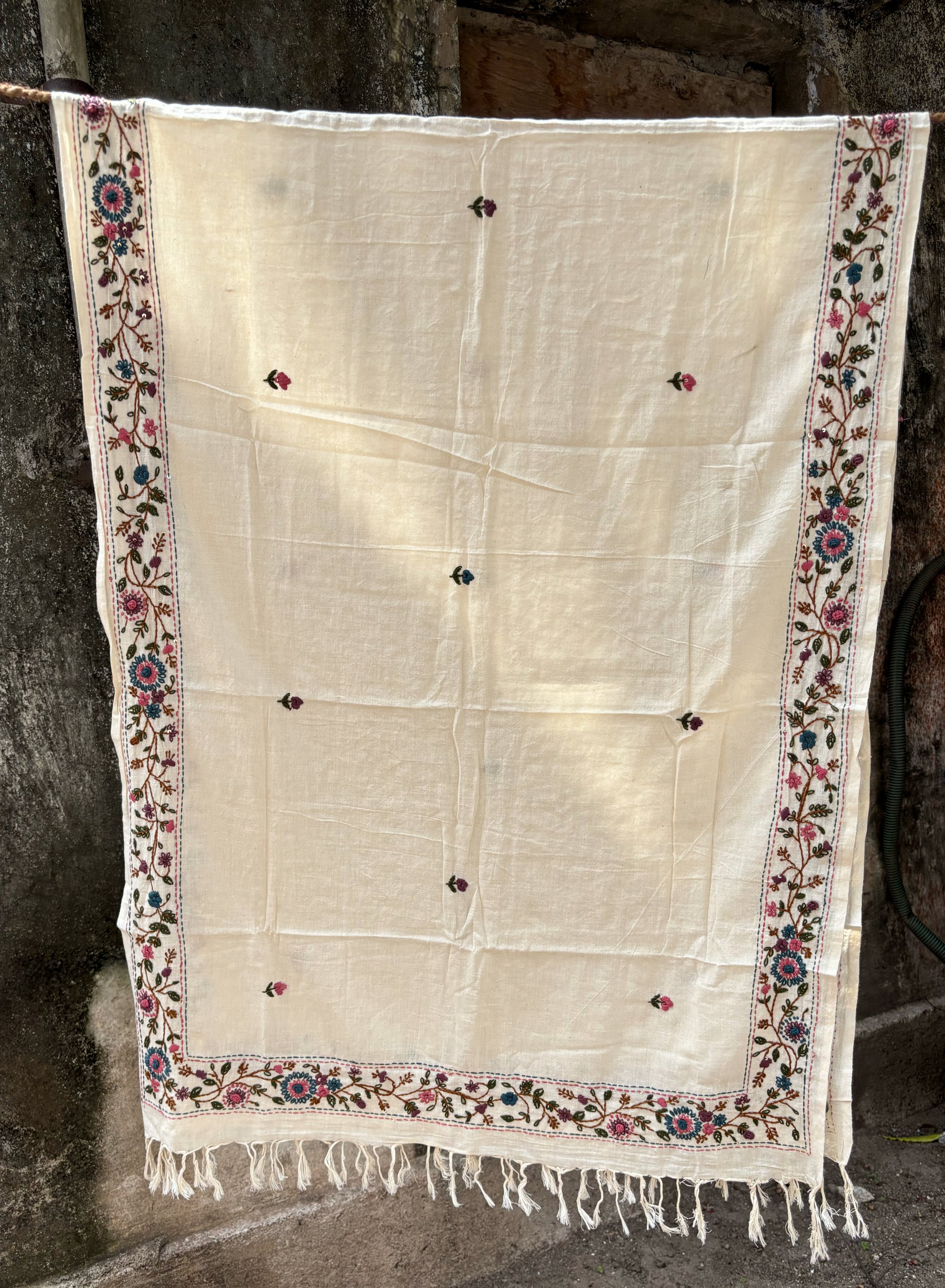 Juhi hand spun and handwoven off-white cotton dupatta with floral embroidered borders, scattered floral buds, and handcrafted tassels.