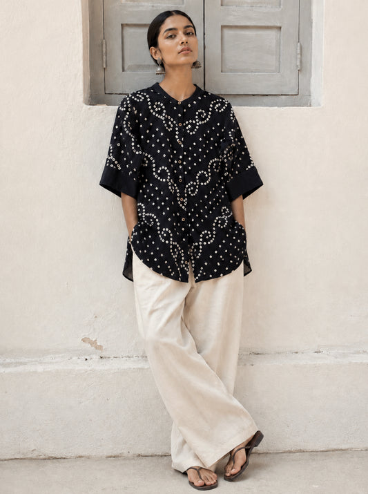 Woman’s black hand tie dyed Bandhani relaxed fit shirt in cotton satin with soft mandarin collar and ivory vine motifs