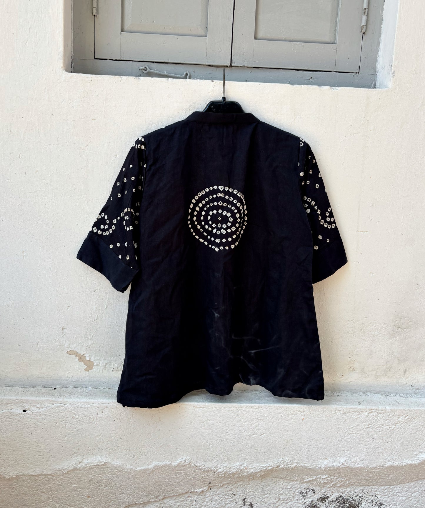 Woman’s black hand tie dyed Bandhani relaxed fit shirt in cotton satin with soft mandarin collar and ivory vine motifs
