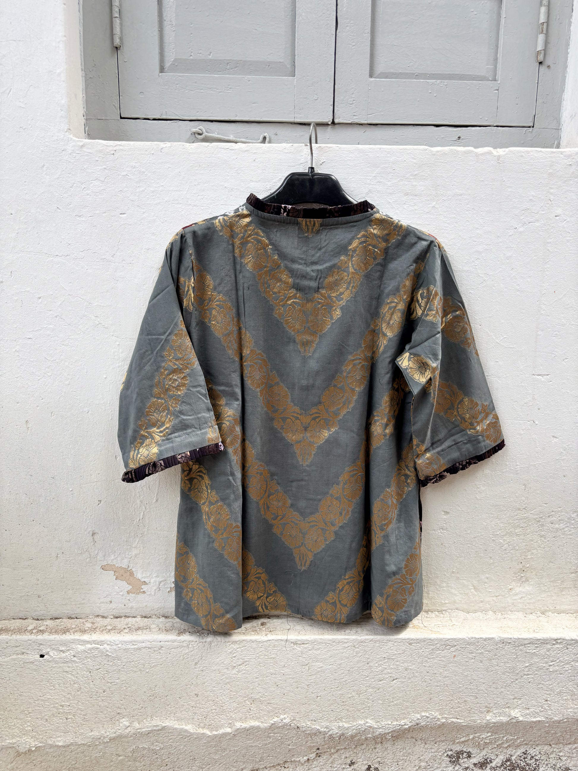 Handcrafted Bandhani festive cotton shirt in Smoky Grey, Crimson Red and Classic Black with antique gold woven floral motifs, a pleated round neckline, front button placket and relaxed fit.
