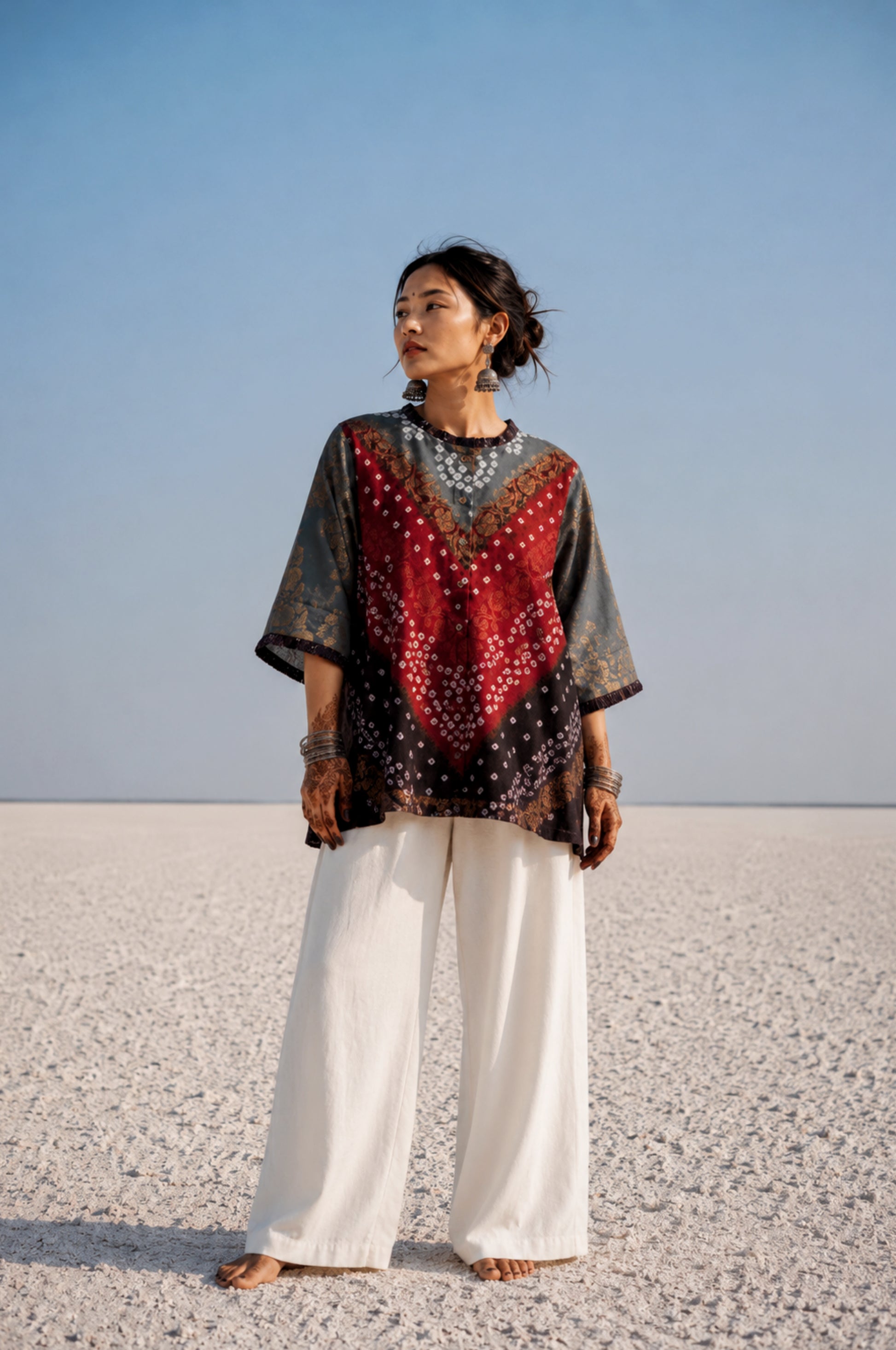 Handcrafted Bandhani festive cotton shirt in Smoky Grey, Crimson Red and Classic Black with antique gold woven floral motifs, a pleated round neckline, front button placket and relaxed fit.
