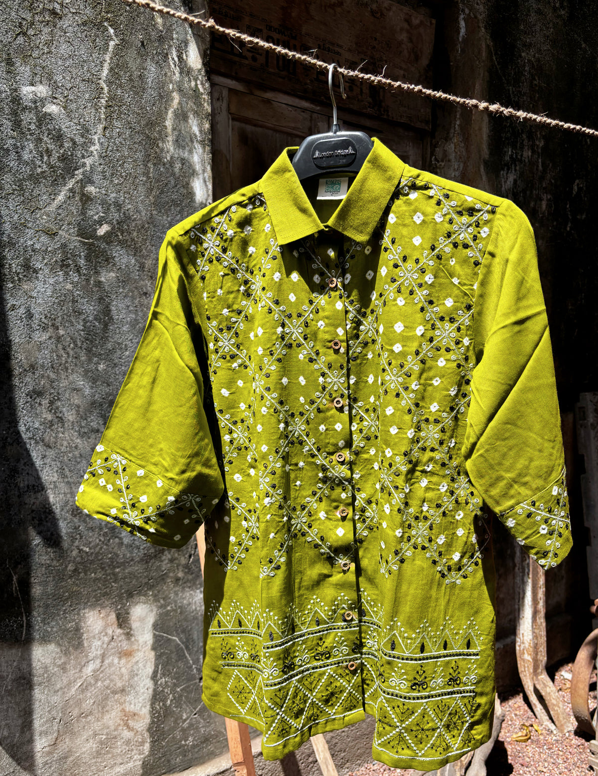 Kairi olive-lime green hand tie-dyed Bandhani cotton satin shirt with ivory Bandhani, geometric machine embroidery and embroidered hem.