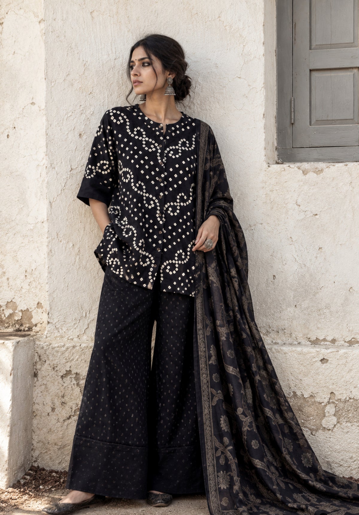 Kajal deep black Bandhani shirt with ivory motifs, charcoal-black Farshi pants and woven floral dupatta