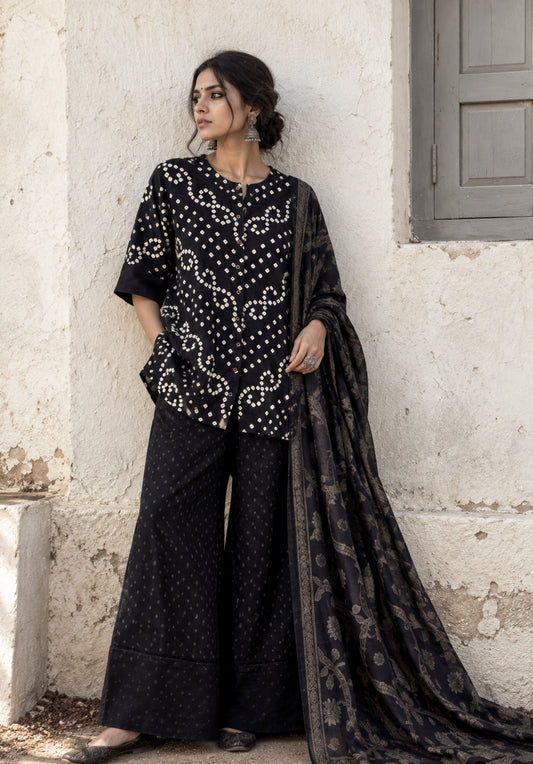 Kajal deep black Bandhani shirt with ivory motifs, charcoal-black Farshi pants and woven floral dupatta
