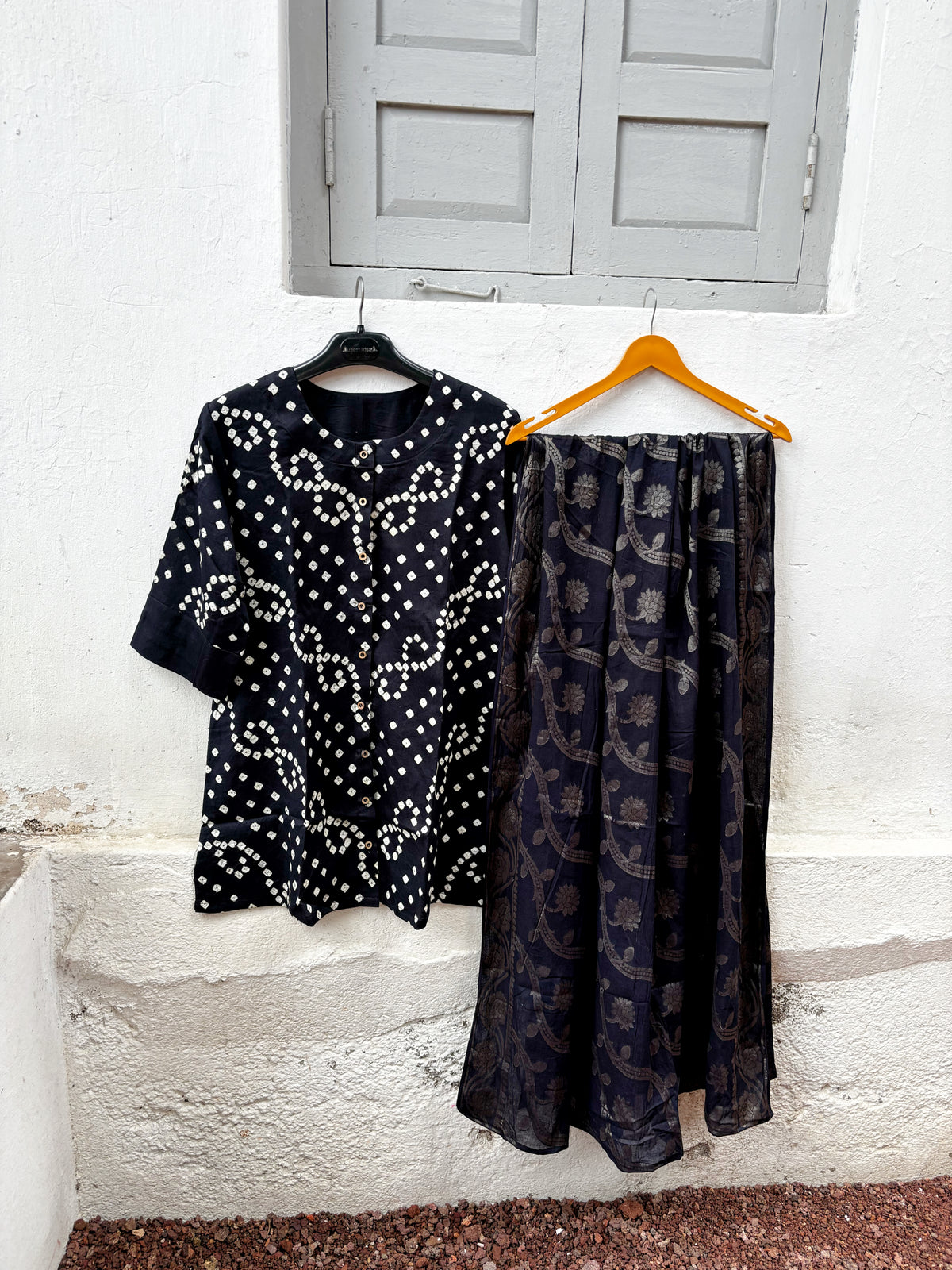 Kajal deep black Bandhani shirt with ivory motifs, charcoal-black Farshi pants and woven floral dupatta