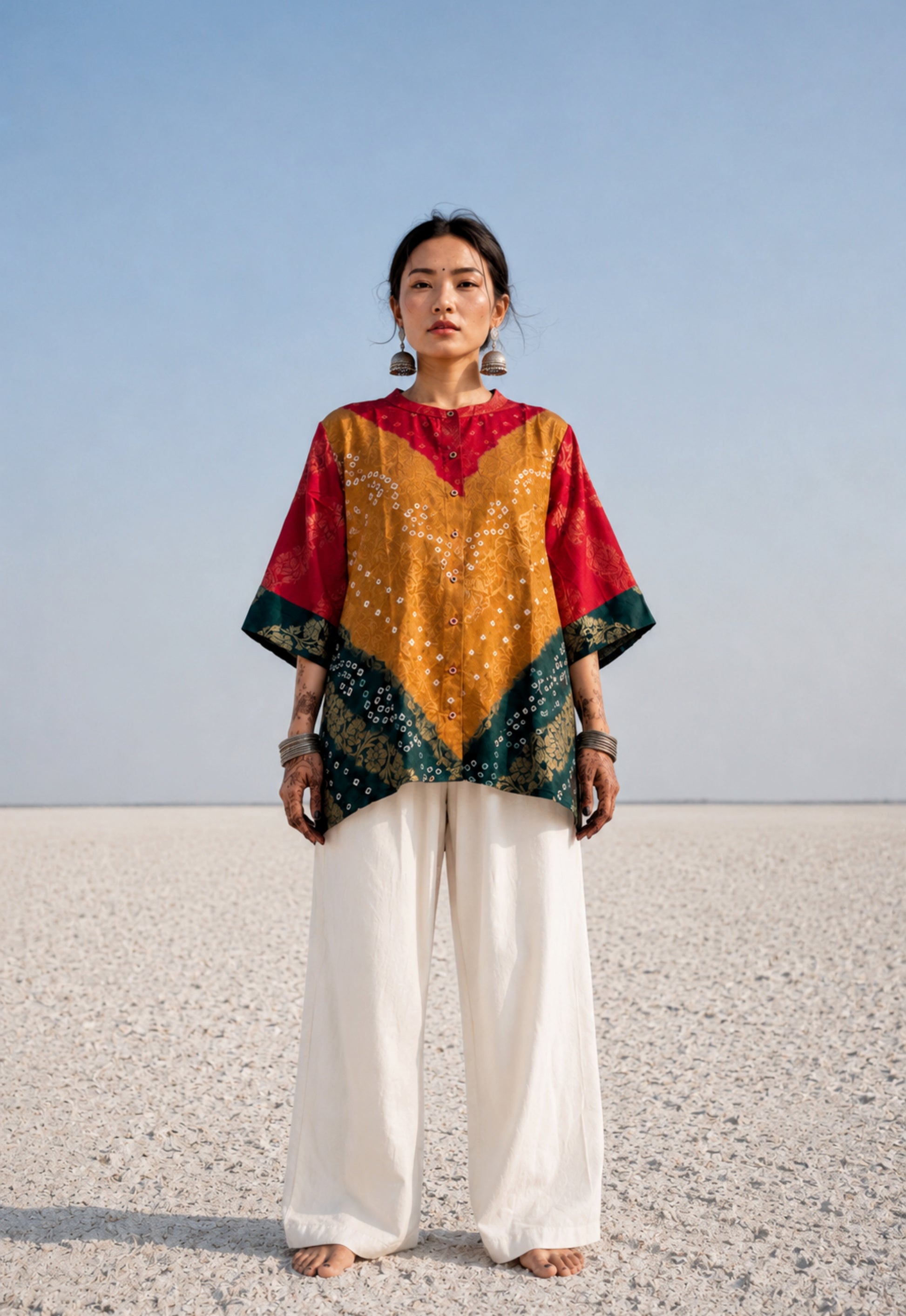 Handcrafted Bandhani festive cotton shirt in Crimson Red, Antique Mustard and Forest Green with antique gold woven floral motifs, mandarin band collar, front button closure, relaxed fit and three-quarter sleeves.