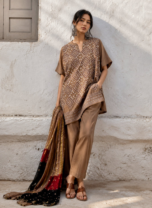 Woman wearing Kasturi brown Bandhani coord set with embroidered kurta, matching pants and tricolour dupatta