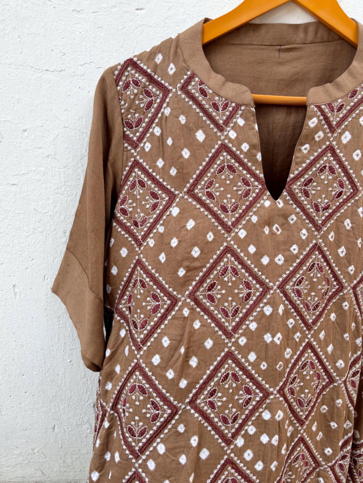 Kasturi light brown Bandhani kurta with geometric machine embroidery and white Rai Bandhani motifs
