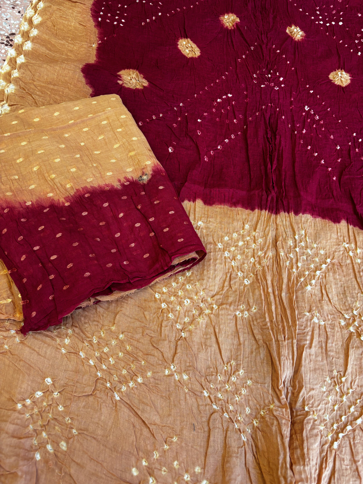 Kasturi Gul hand tie-dyed Bandhani cotton saree in camel brown and deep wine maroon with white geometric and floral motifs