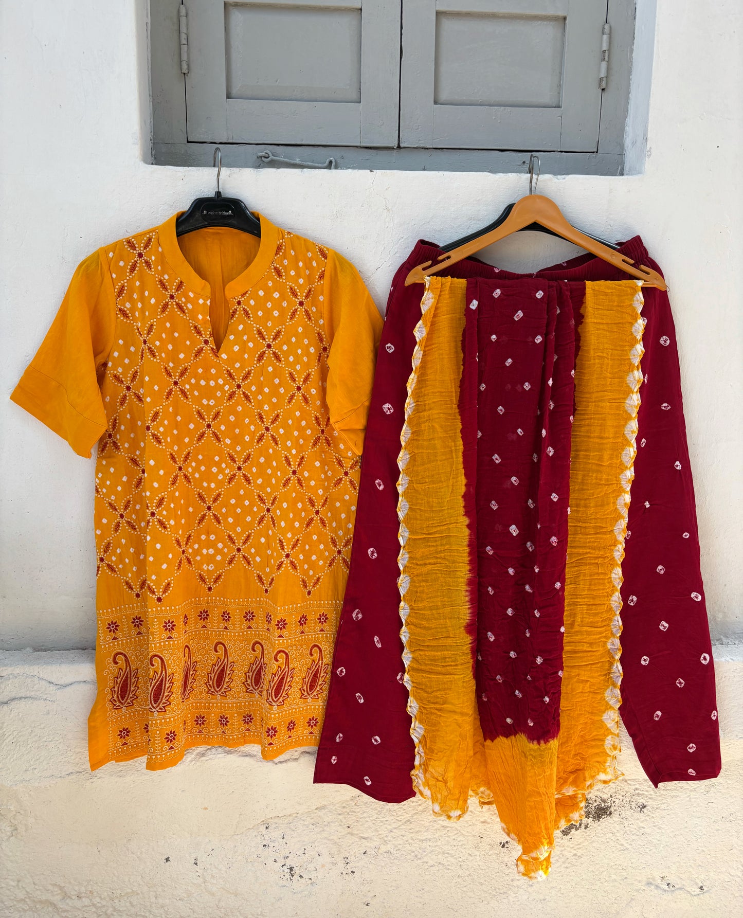 Yellow and maroon Bandhani three-piece set for women with embroidered kurta, comfortable-fit pants and hand tie dyed dupatta