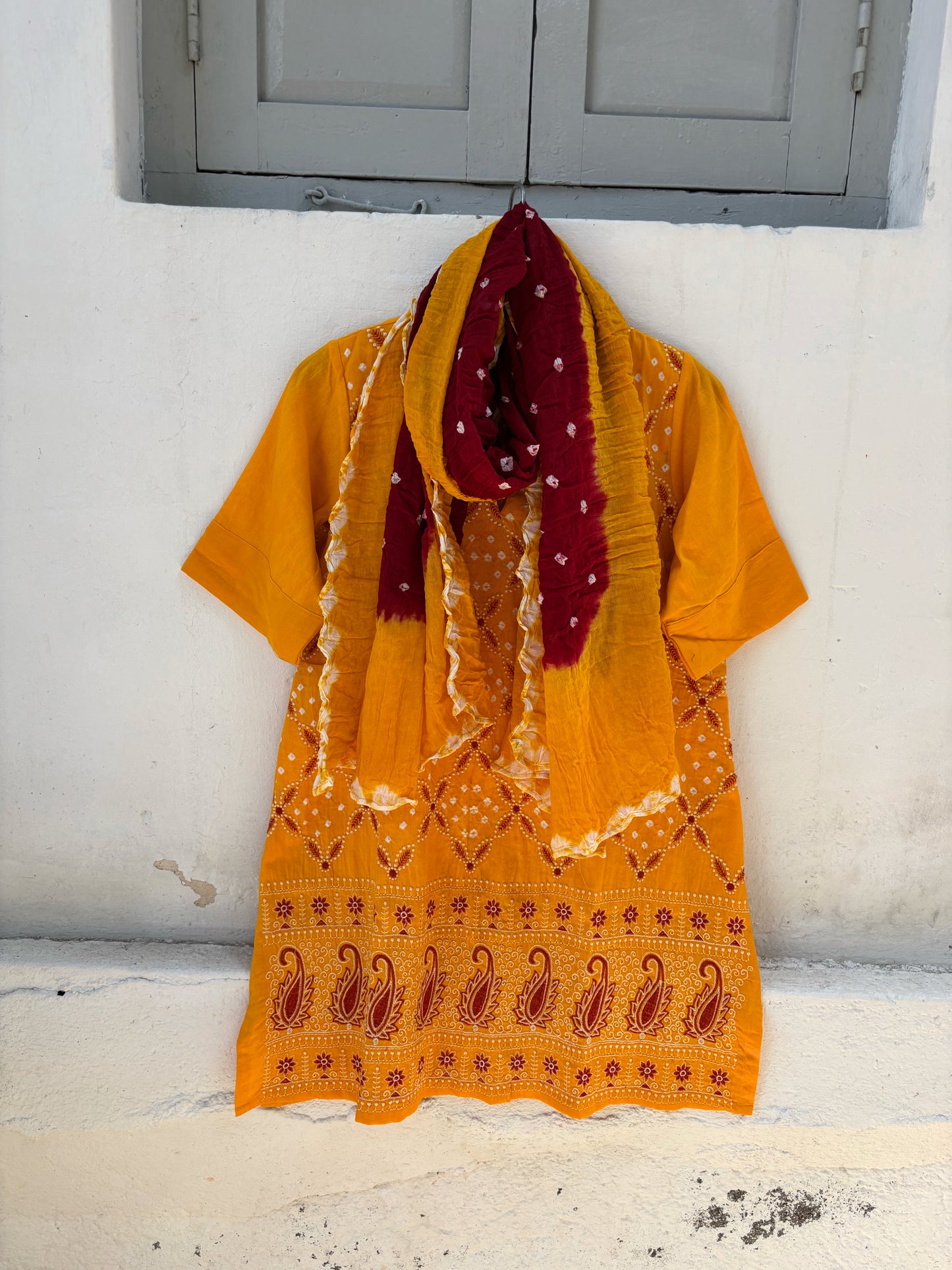 Yellow and maroon Bandhani three-piece set for women with embroidered kurta, comfortable-fit pants and hand tie dyed dupatta
