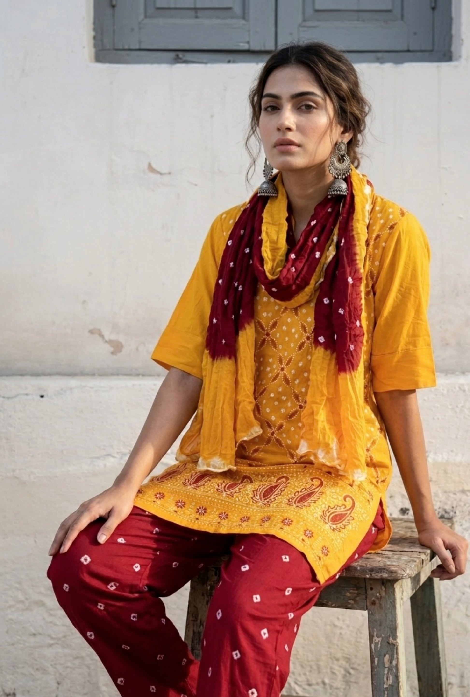 Yellow and maroon Bandhani three-piece set for women with embroidered kurta, comfortable-fit pants and hand tie dyed dupatta