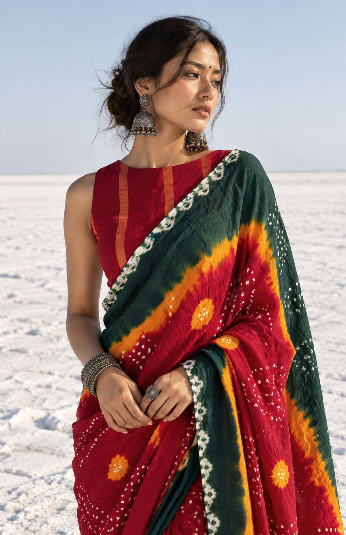 Kesari Gulal hand tie-dyed Bandhani cotton saree in green, maroon and orange with white floral and geometric motifs