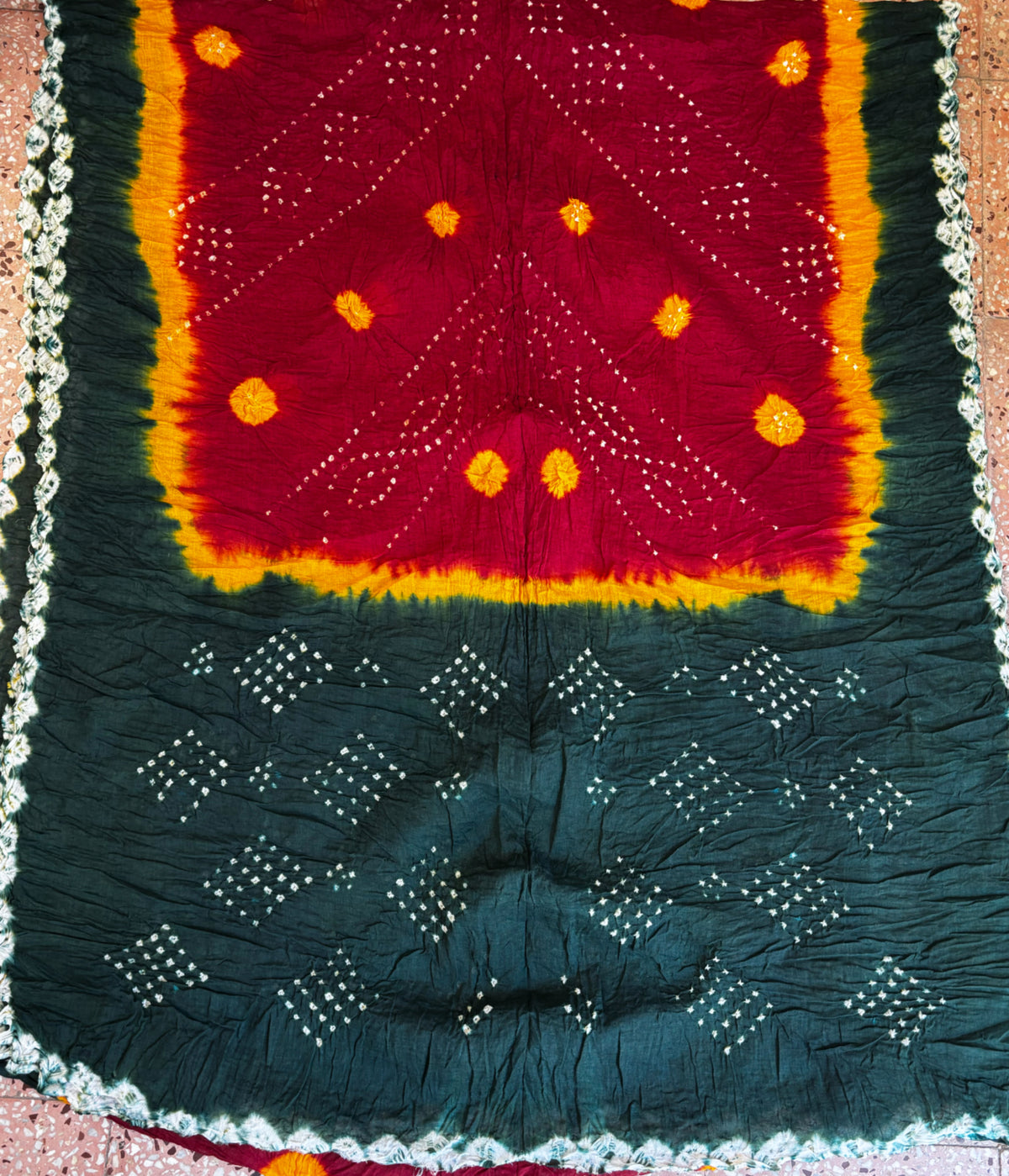 Kesari Gulal hand tie-dyed Bandhani cotton saree in green, maroon and orange with white floral and geometric motifs