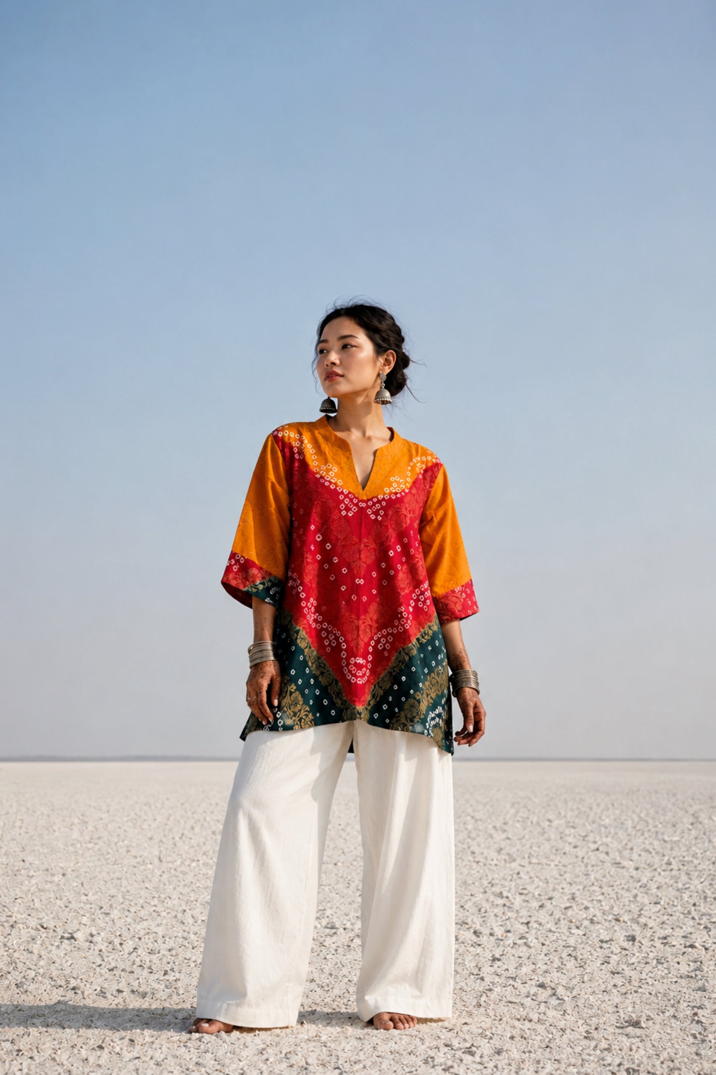 Handcrafted Bandhani festive cotton top in Saffron Yellow, Crimson Red and Deep Teal with antique gold woven floral motifs, mandarin V-neck, relaxed fit and three-quarter sleeves.