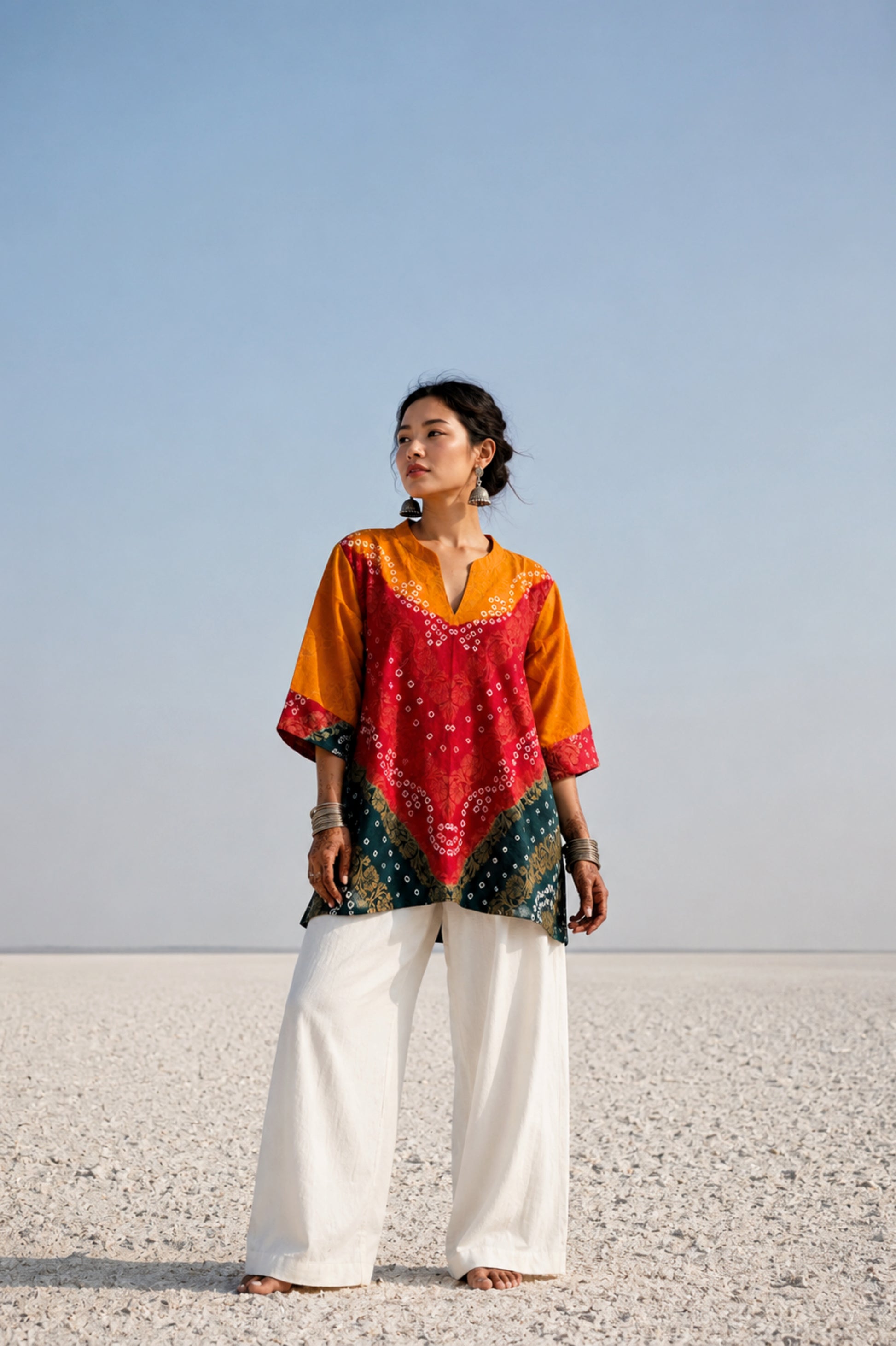 Handcrafted Bandhani festive cotton top in Saffron Yellow, Crimson Red and Deep Teal with antique gold woven floral motifs, mandarin V-neck, relaxed fit and three-quarter sleeves.