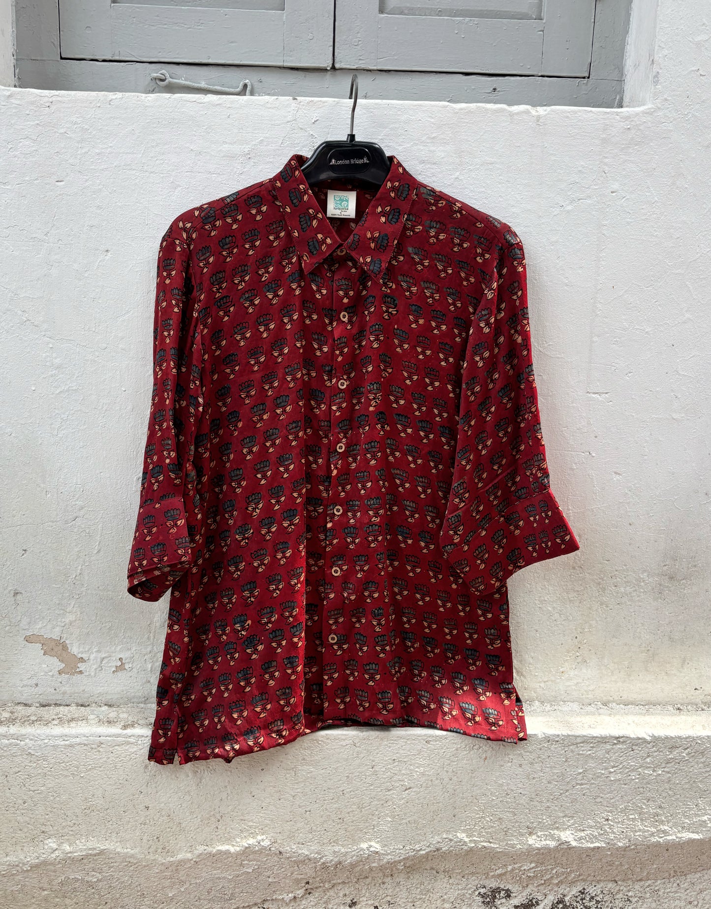 Natural dyed Ajrakh hand block printed modal silk relaxed shirt for women in deep madder red with delicate floral booti motifs.