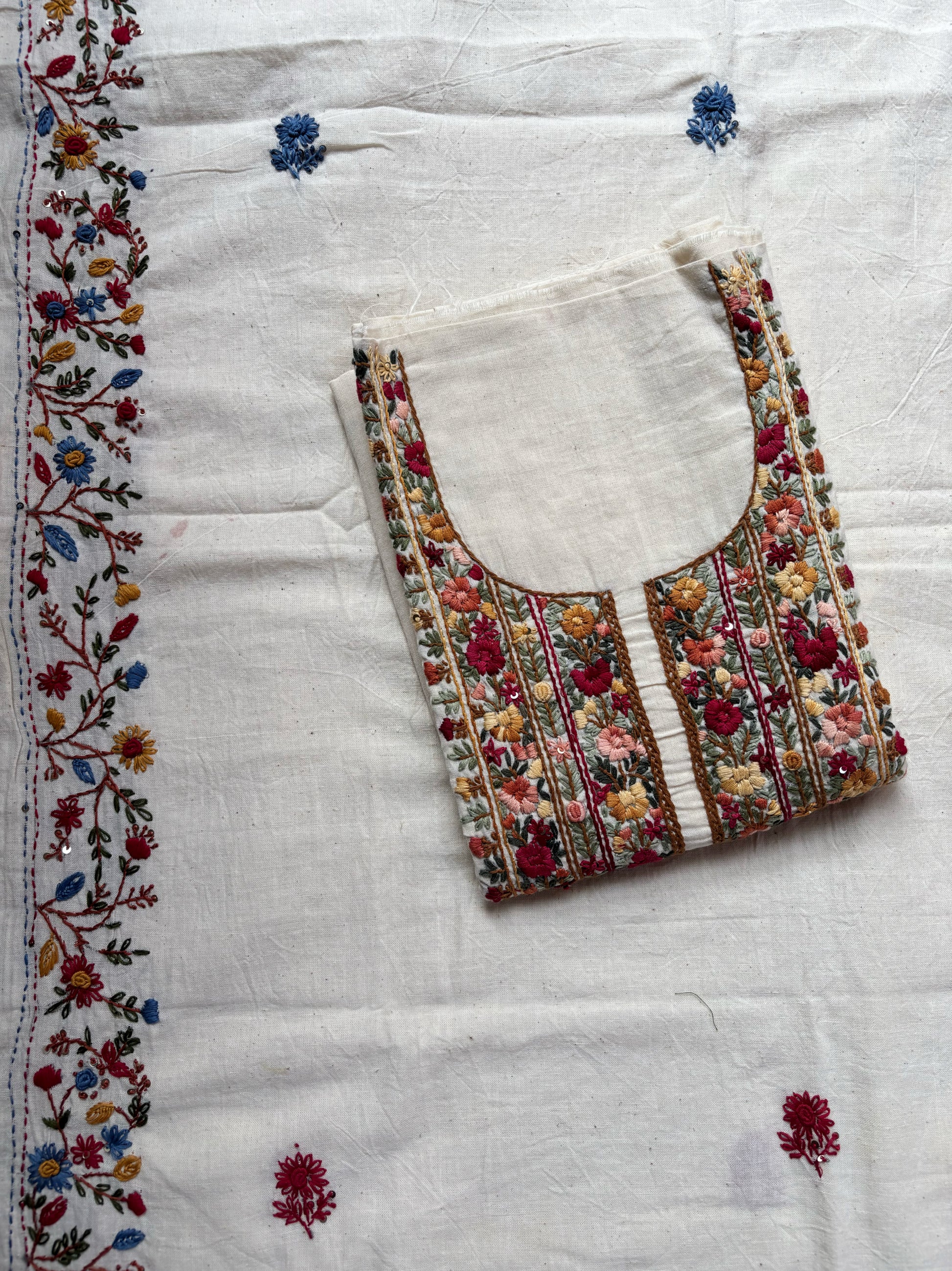 Handspun cotton unstitched kurta dupatta set featuring a richly hand embroidered floral yoke with delicate butti motifs and a matching embroidered dupatta in warm ivory tones.
