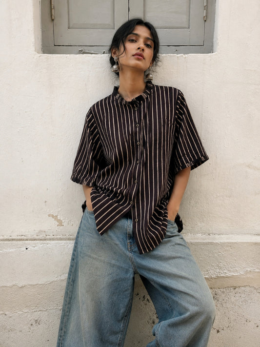 Ajrakh hand block printed cotton shirt with natural dyed beige stripes on a deep midnight base, pleated neckline, pleated sleeve hems and relaxed fit.