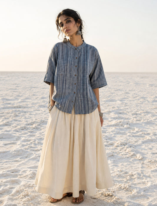 Hand spun handwoven cotton striped shirt in mist blue and ivory. Slow-made with a soft mandarin collar, relaxed fit and breathable woven texture.