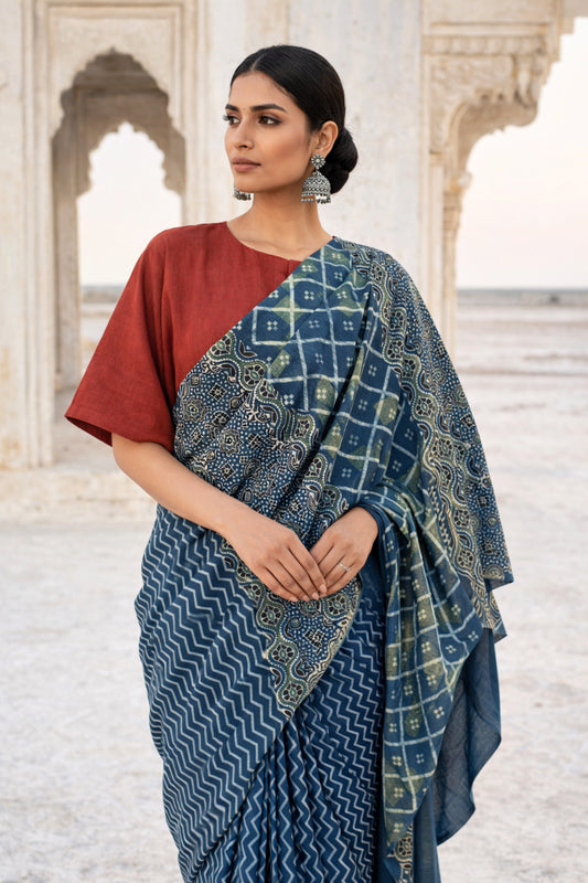 Indigo Ajrakh cotton saree with geometric and traditional motifs.