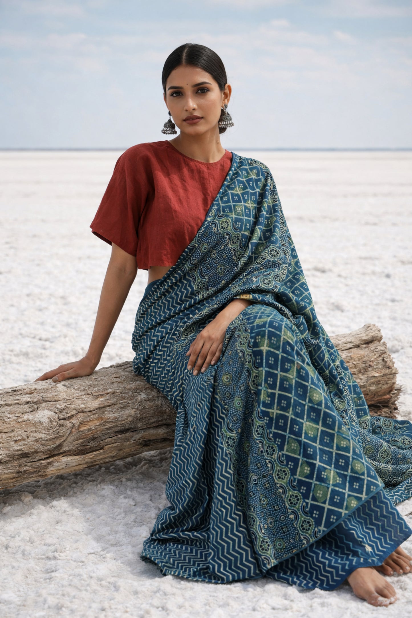 Indigo Ajrakh cotton saree with geometric and traditional motifs.