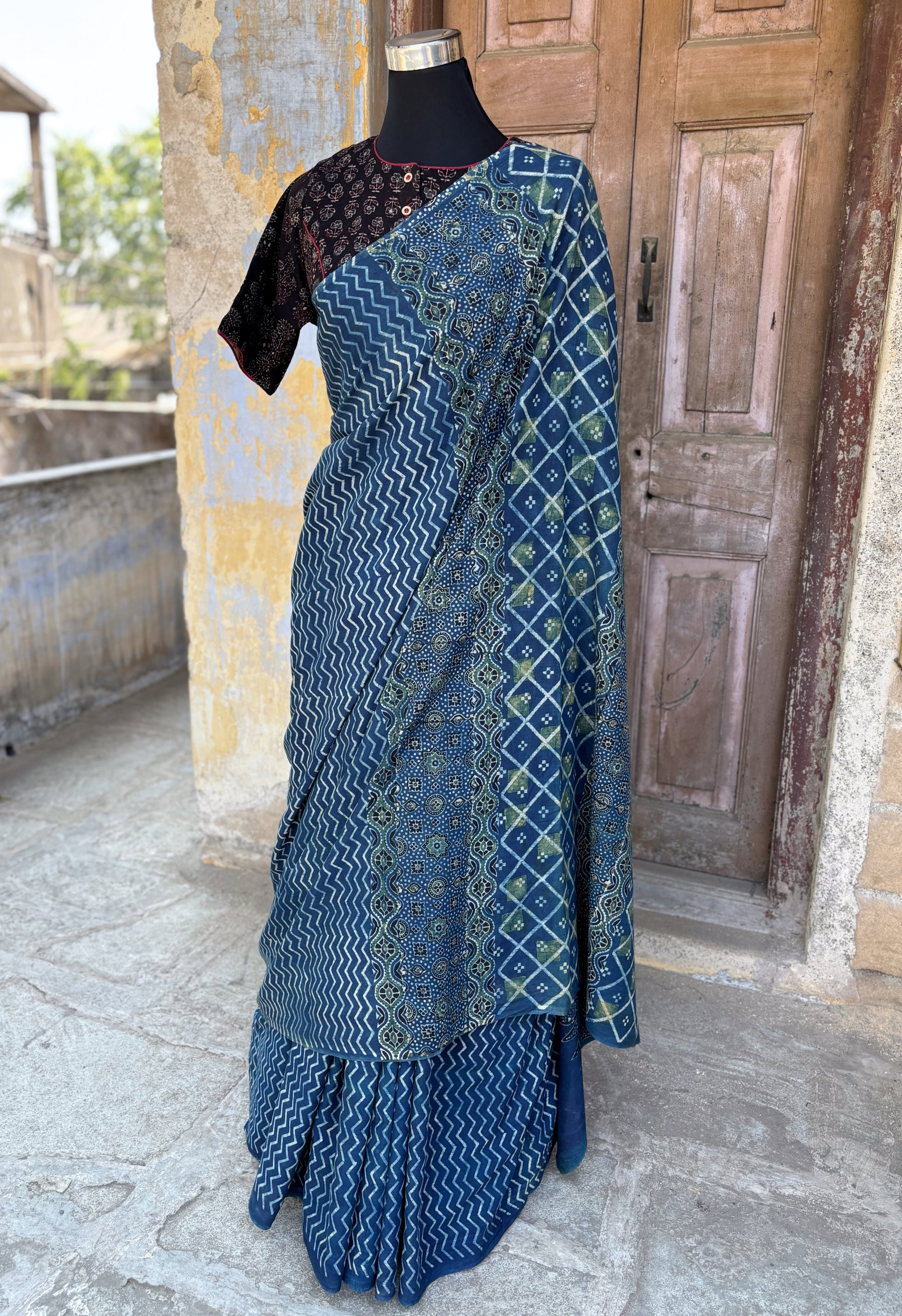 Indigo Ajrakh cotton saree with geometric and traditional motifs.