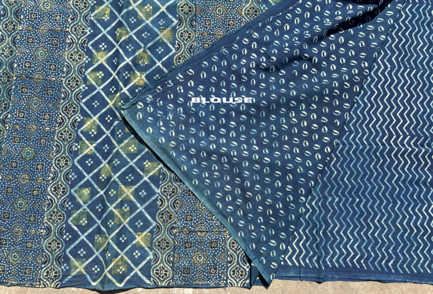 Indigo Ajrakh cotton saree with geometric and traditional motifs.