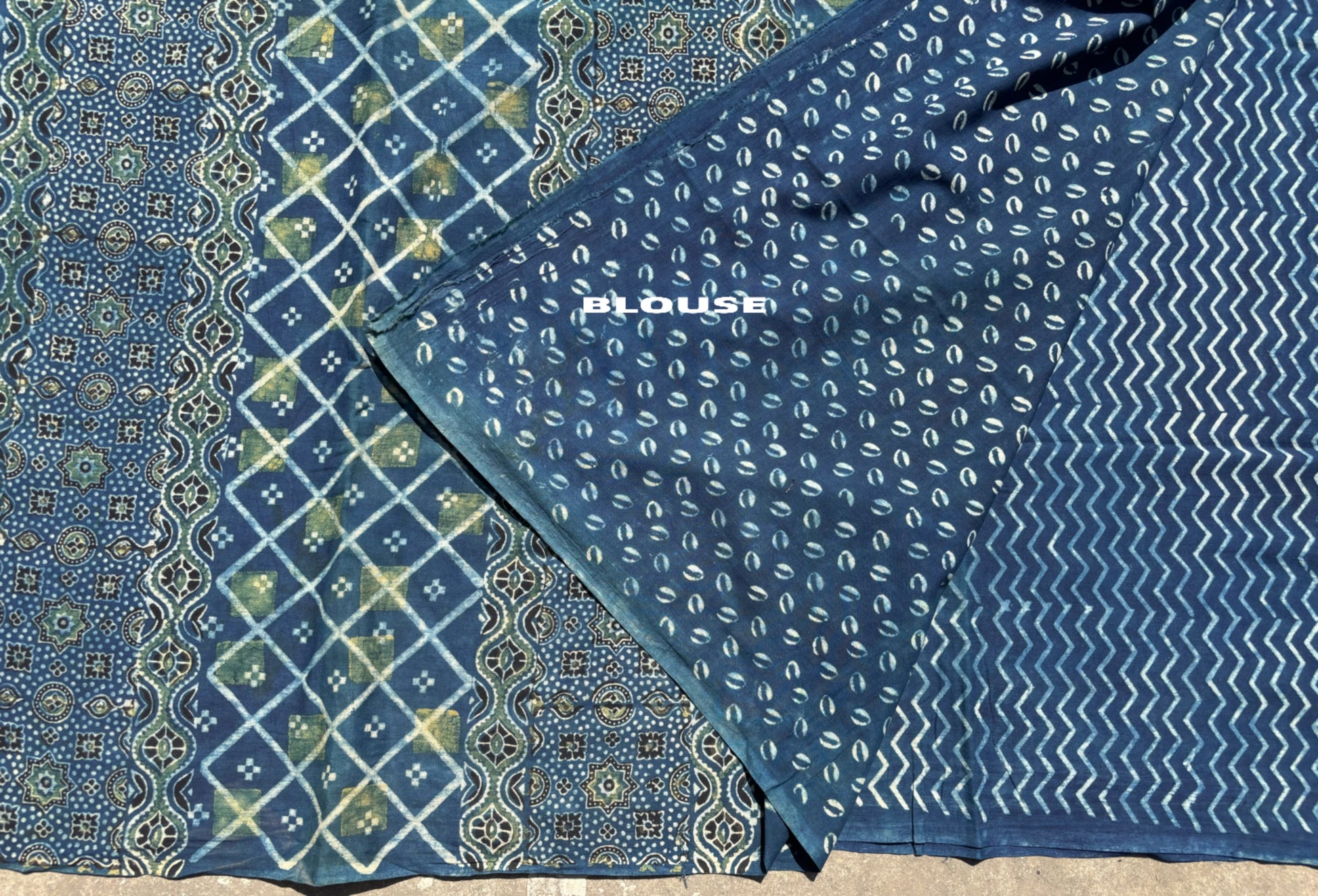 Indigo Ajrakh cotton saree with geometric and traditional motifs.