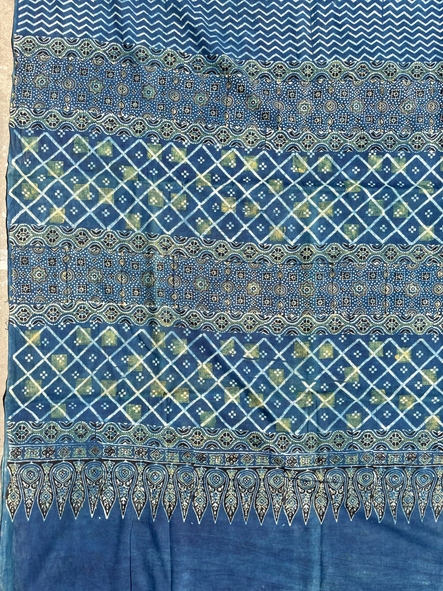 Indigo Ajrakh cotton saree with geometric and traditional motifs.