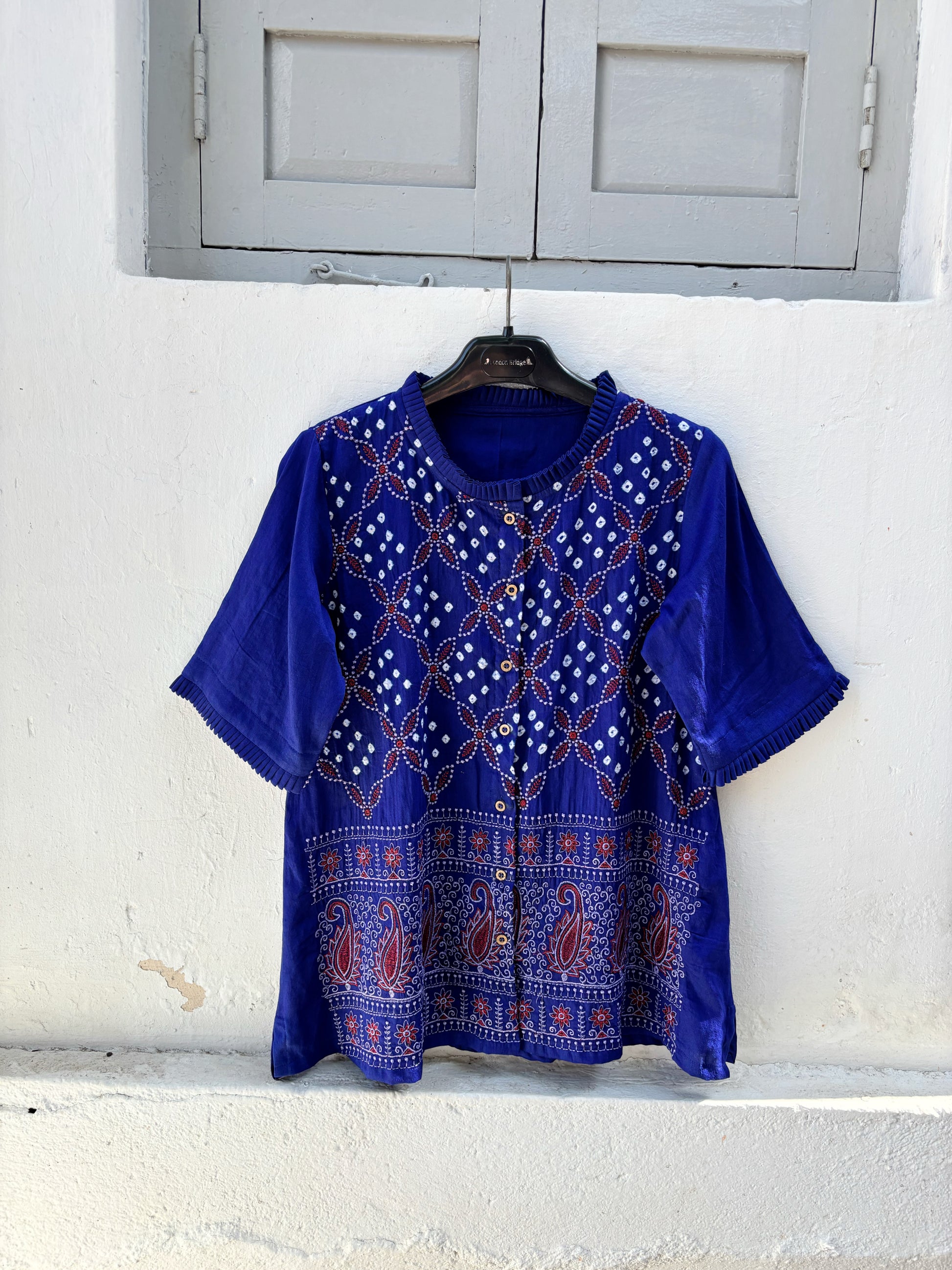 Neeli Dani blue Bandhani embroidered cotton satin relaxed fit shirt with pleated neckline for women