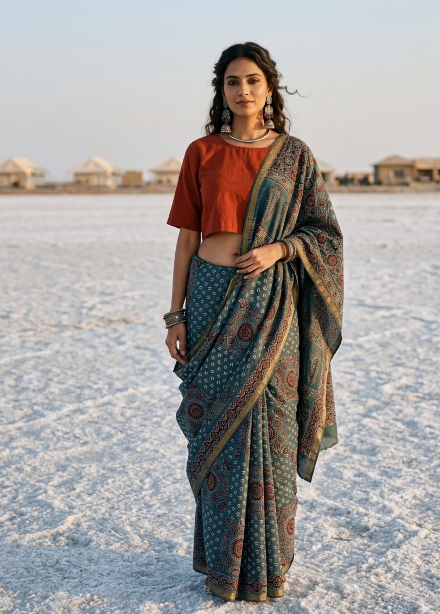 Indigo Ajrakh hand block printed cotton saree featuring traditional circular and geometric motifs with a thin border, paired with a madder dyed Ajrakh blouse piece.