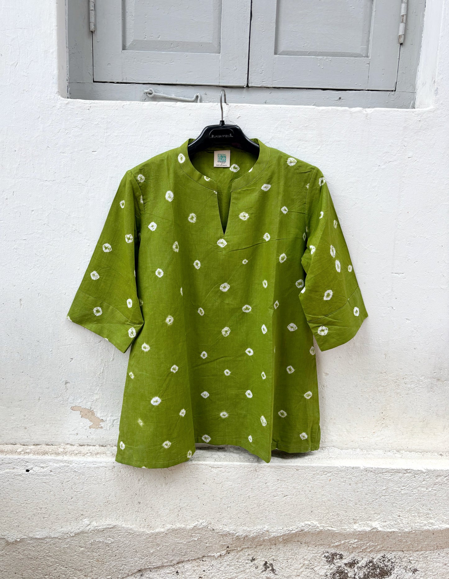 Women's olive green cotton Bandhani shirt with a V-slit neckline.