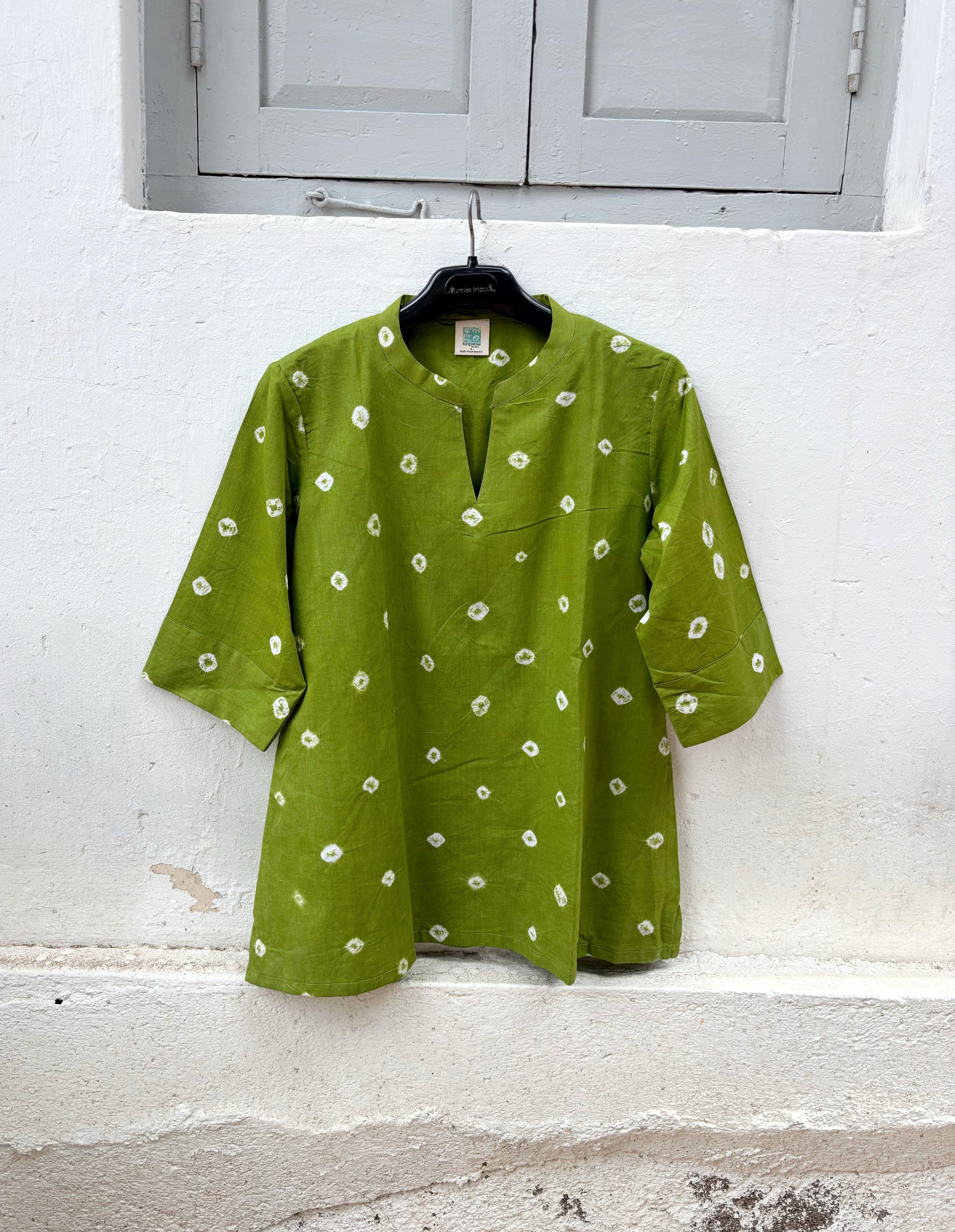 Women's olive green cotton Bandhani shirt with a V-slit neckline.