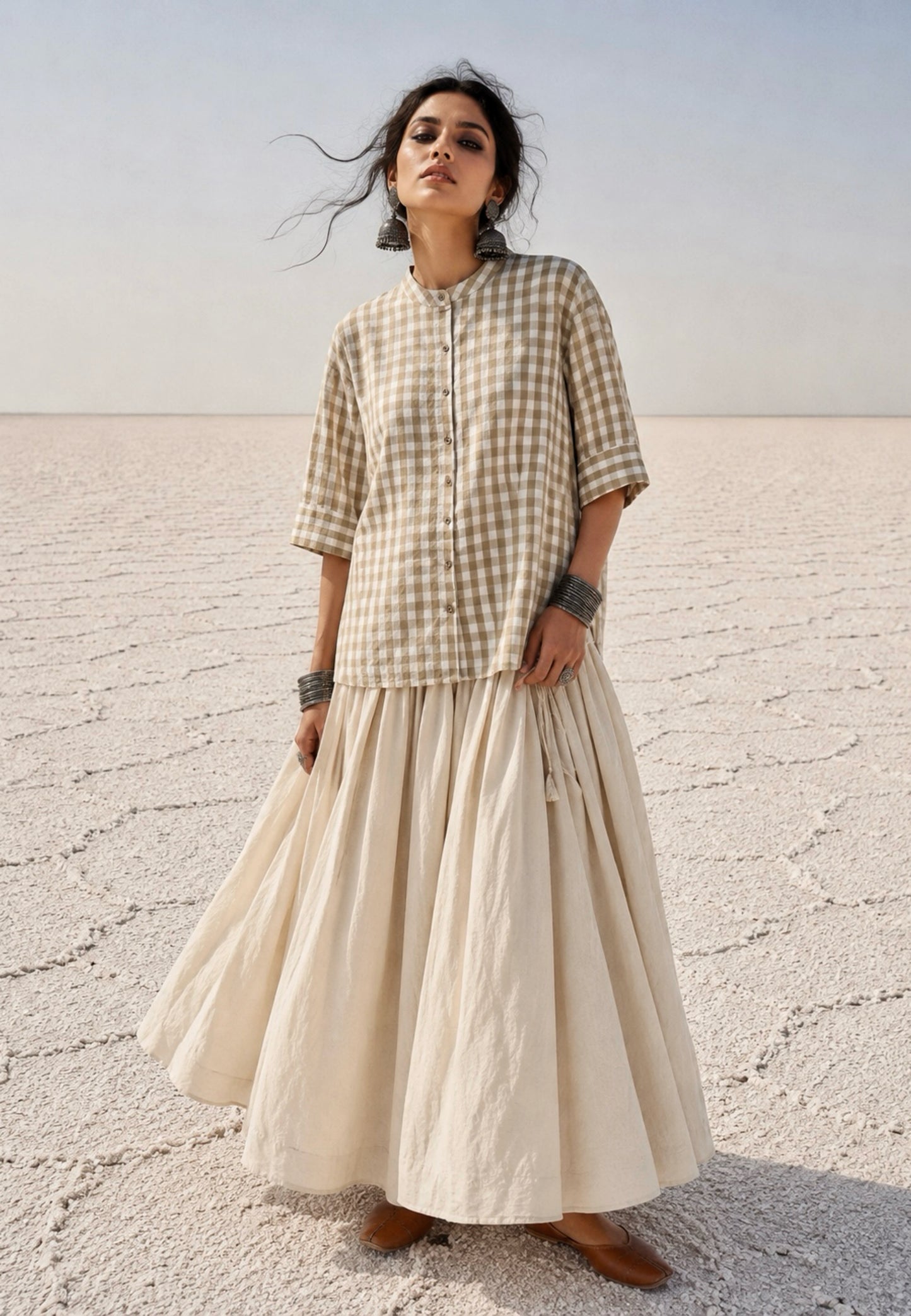 Olive Meadow hand spun handwoven cotton checks shirt in earthy olive and natural ivory gingham with a soft mandarin collar, wooden buttons and relaxed silhouette, paired with a raw undyed hand spun handwoven cotton skirt.