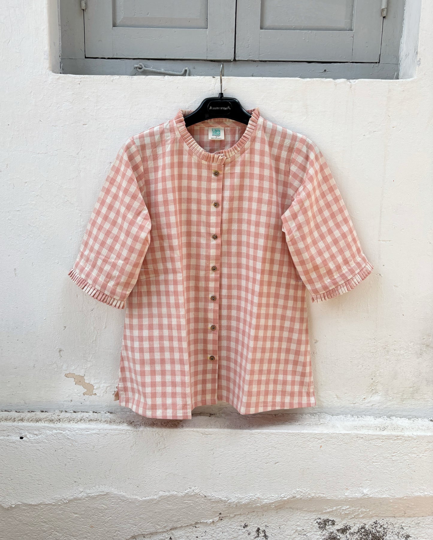 Peach Blush hand spun handwoven cotton checks shirt in pinkish peach and natural ivory with pleated neckline, pleated sleeve hems and wooden buttons.