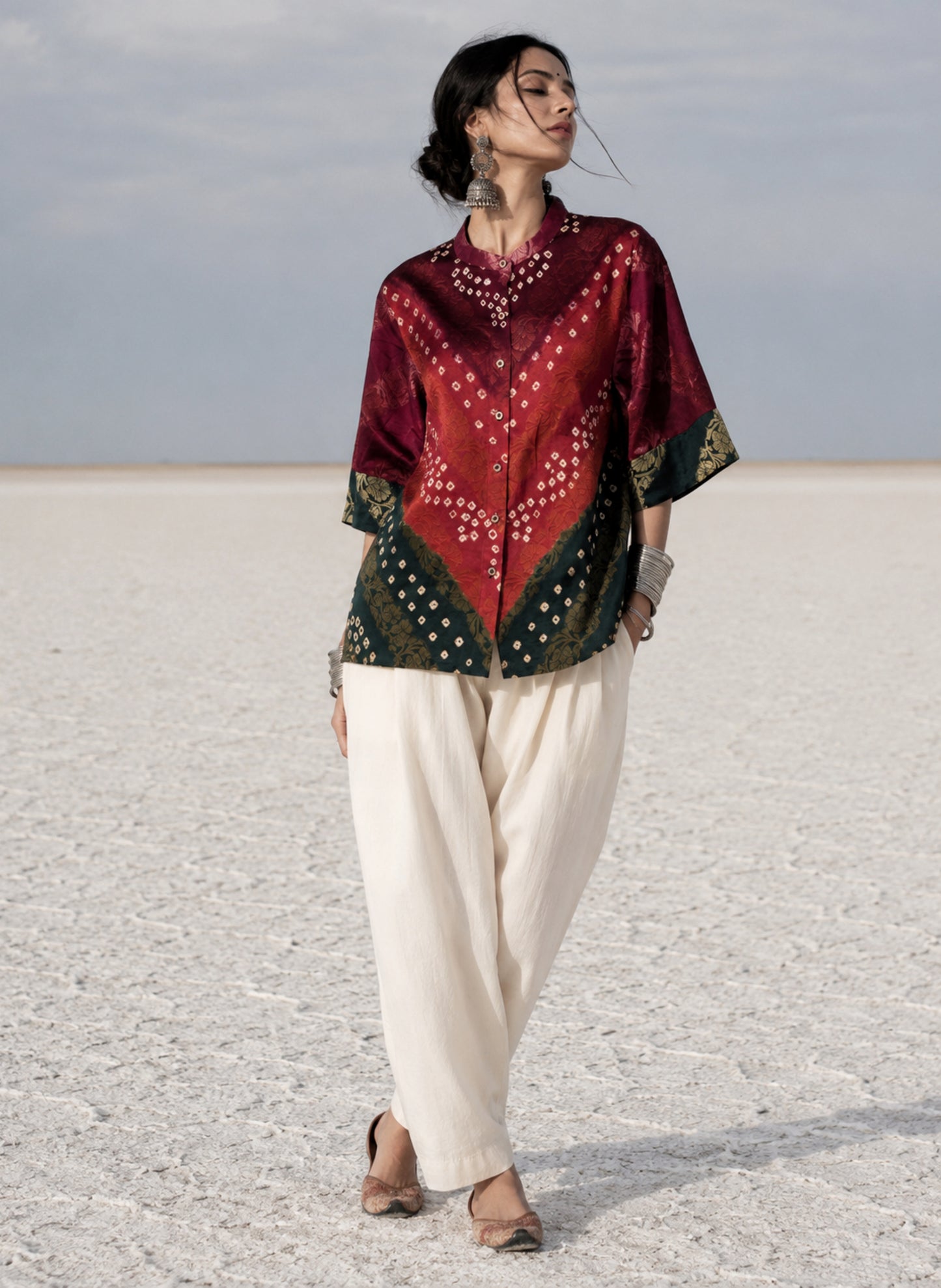 Handcrafted Bandhani festive cotton shirt in Wine Maroon, Rust Red and Deep Emerald Green with antique gold woven floral motifs, soft mandarin collar, short button placket, relaxed fit and three-quarter sleeves.
