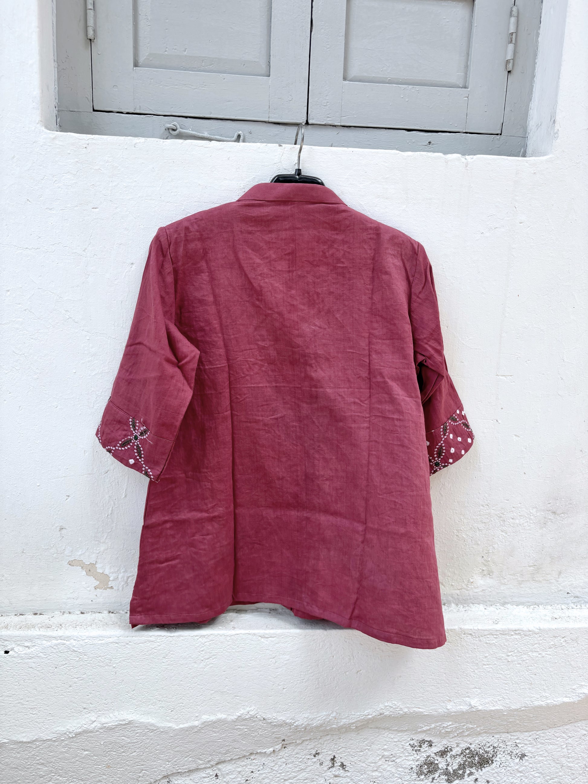 Dusty berry rose cotton satin Bandhani shirt with machine embroidery on the front panel and sleeve cuffs, soft mandarin collar and relaxed fit.
