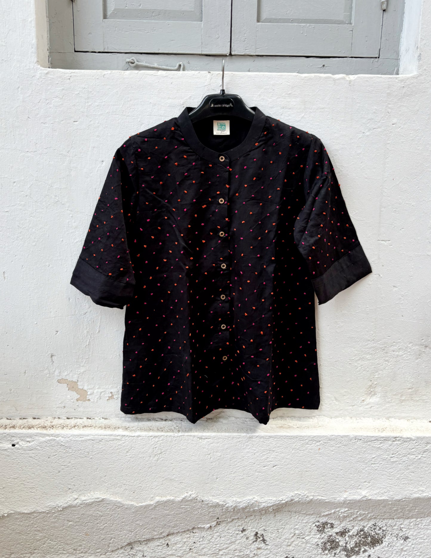 Black cotton satin shirt with colourful hand-tied thread knot detailing on the front, soft mandarin collar and plain back.