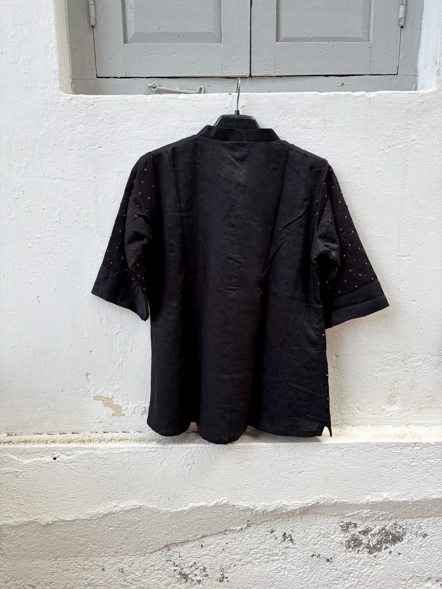 Black cotton satin shirt with colourful hand-tied thread knot detailing on the front, soft mandarin collar and plain back.