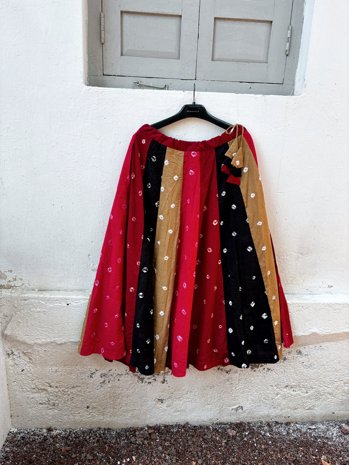 Rangotsav multicolour hand tie-dyed Bandhani cotton skirt with red, black and mustard panels and ivory motifs