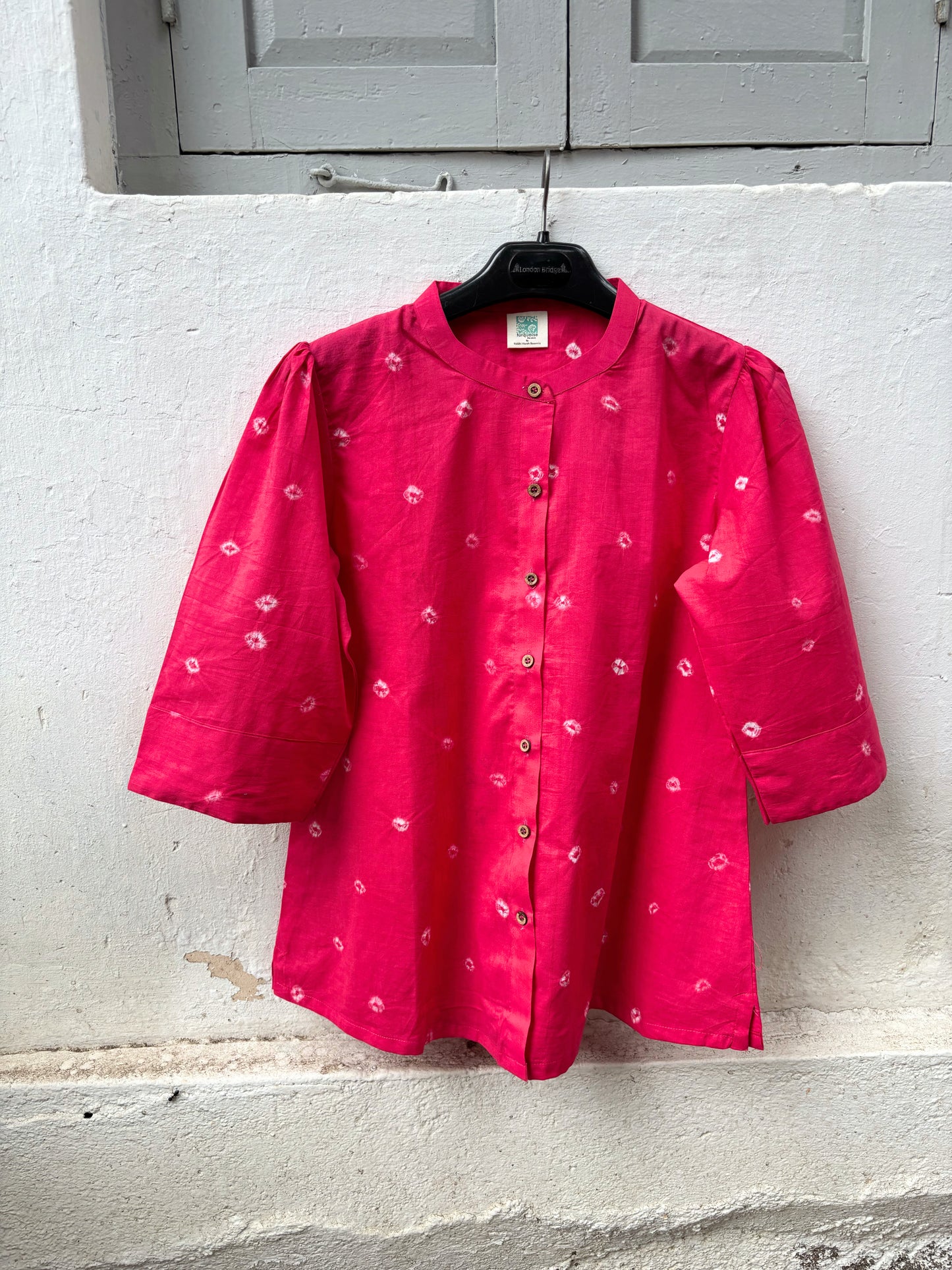 Relaxed fit raspberry pink Bandhani cotton shirt with wooden buttons.
