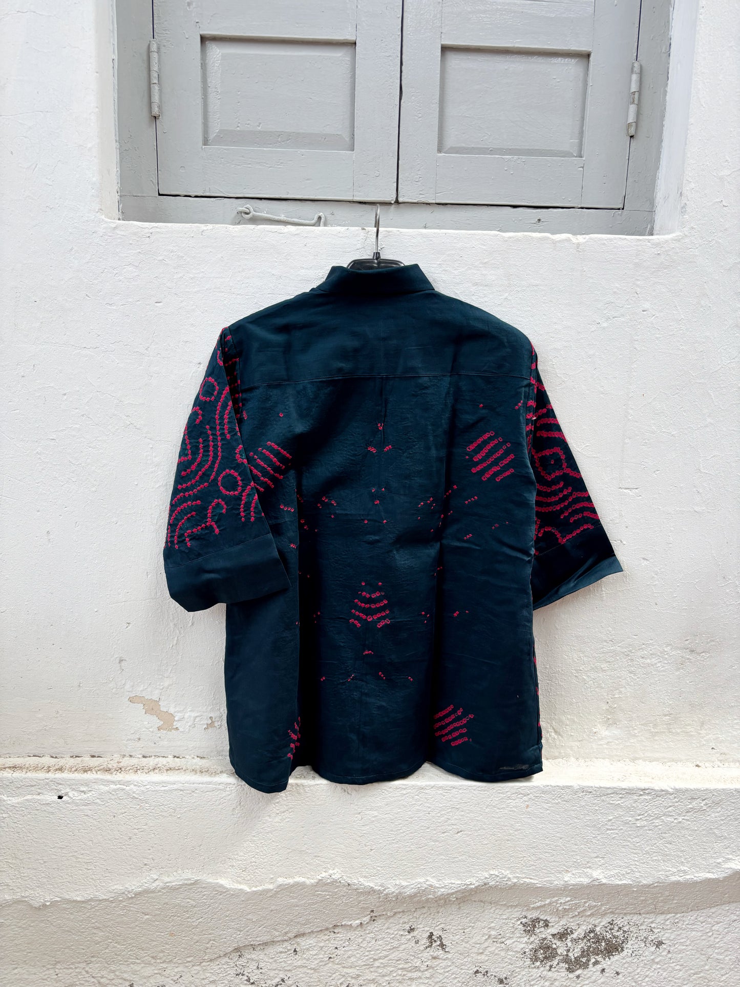 Midnight Blue hand tie-dyed Bandhani cotton shirt with vibrant Magenta motifs, classic shirt collar and relaxed fit from the Jhankar collection.
